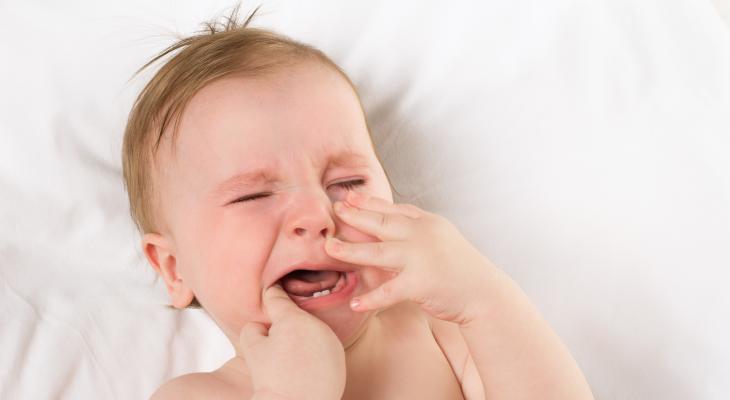 banner of A Teething Child is Rarely Happy to Be Experiencing the Process